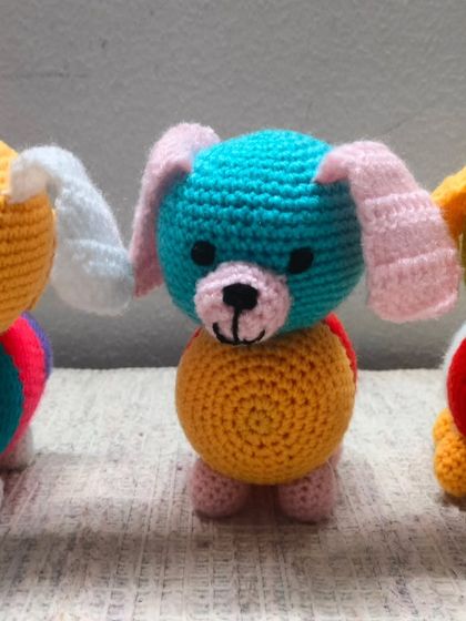 Three of my small, handmade dogs in a row. Each one is made with a different combination of bright colors.