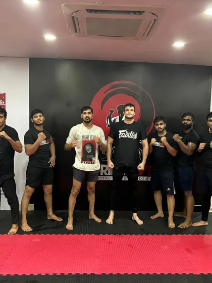 The evening grappling session crew with their coach. This is where our students hone their ground game.