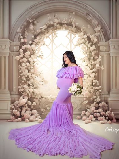 A duplicate of 109, showcasing the beautiful silhouette of the mother-to-be against a dreamy, floral studio backdrop.