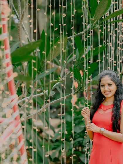 A close-up portrait against a wall of lights, creating a beautiful and festive background.