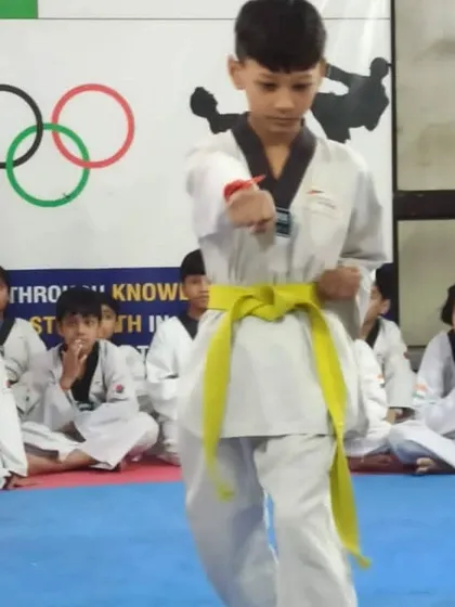 A young student demonstrates his punching technique during a belt promotion test. We test for focus and power.