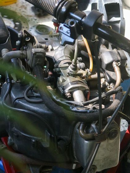 An exposed scooter engine in our workshop, waiting for curious minds to explore its inner workings.