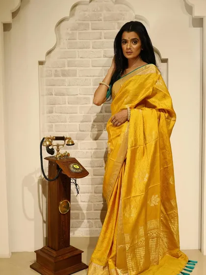The full look from the yellow saree shoot, set against a vintage backdrop.