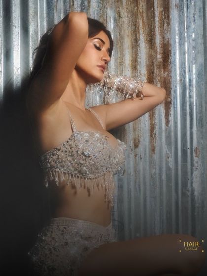 A serene moment amidst the sparkle. The makeup is glowing and radiant, designed to catch the light beautifully.