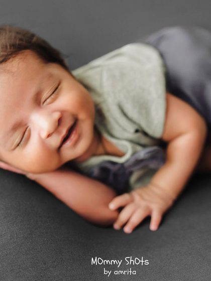 A repeat of the smiling newborn, a perfect example of a precious moment captured with skill.