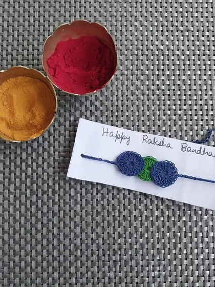 A simple, modern rakhi design with three small crochet circles.