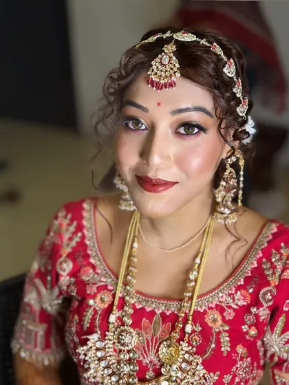 The final look is a masterpiece of bridal beauty. The makeup is radiant, the hair is perfectly styled, and the bride looks absolutely breathtaking.