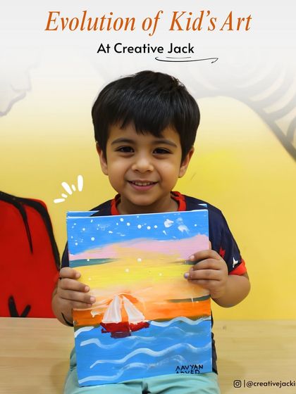 A young boy proudly holds up his colorful painting of a sailboat on the sea, a great example of the evolution of kids' art at my studio.
