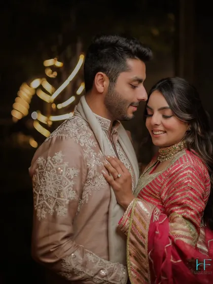 A quiet, happy moment shared between the couple. Their soft smiles and gentle touch create a portrait that is both intimate and full of warmth.