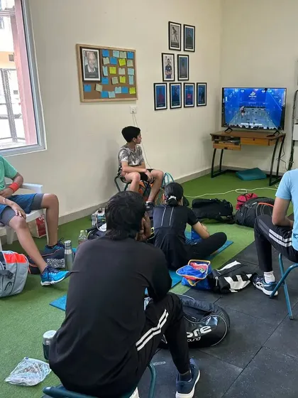 Our players studying game footage. Match analysis is a key part of our 'Total Squash' curriculum.