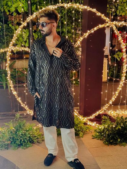 Posing against the festive lights at the OLA Deepavali party.