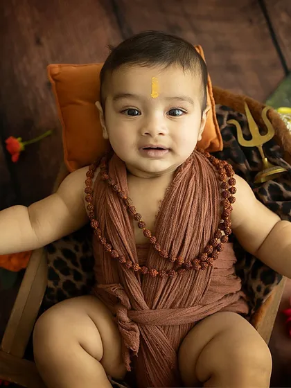 A calm, sweet portrait of the baby in his spiritual-themed setup.