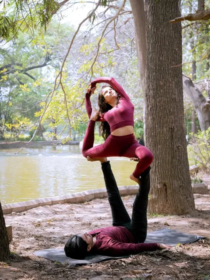 Acro yoga is about trust, communication, and strength. In this beautiful outdoor setting, we explore partner poses like this variation of Natarajasana, creating shapes that are both challenging and beautiful.
