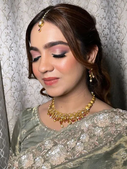The magic of makeup is in the details. This close-up shows the soft pink smokey eye I created for this party look, which beautifully enhances her eyes.