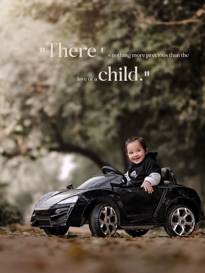 There is nothing more precious than the love of a child. A smiling boy in a hoodie drives his toy car.