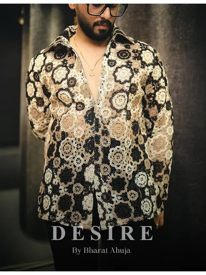 A close-up of the unique crochet-style fabric in earthy tones. This shirt is all about texture and a relaxed, bohemian sense of luxury.