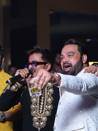 Friends singing along with the music at a Diwali party. These are the candid moments of shared joy that make for the best memories.