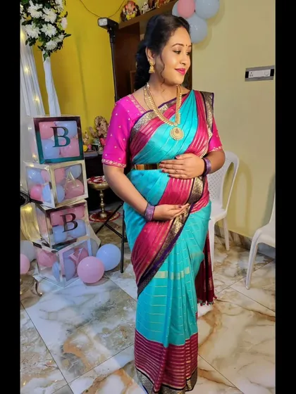 For this mom-to-be's baby shower, I styled a vibrant Mysore silk saree to be both beautiful and comfortable. The drape is adjusted to gracefully accommodate the baby bump, ensuring she feels secure and celebrated.
