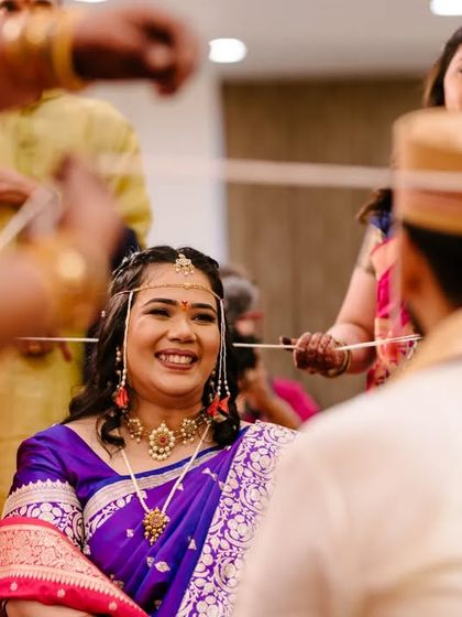 The bride's radiant smile during the 'antarpat' ceremony, a moment of pure anticipation and joy.