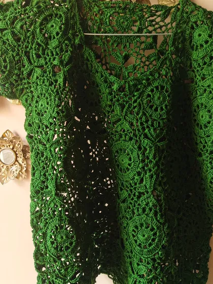The texture and detail of the green lace top are what make it so special. Each circle motif is connected with care to create a seamless, flowing fabric.