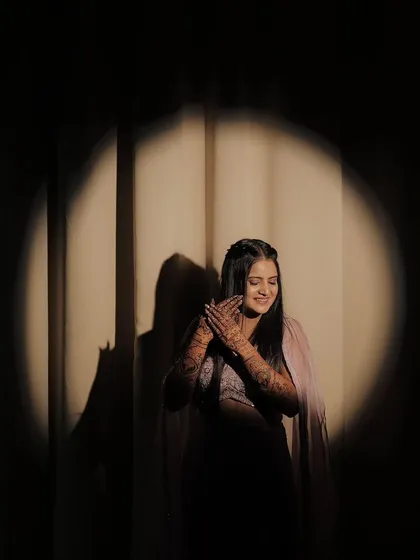 A creative shot using light and shadow to highlight the bride and her beautiful mehandi. We love being part of these memorable photoshoots.