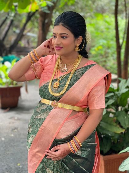 A side profile showcasing the elegant updo and the details of her makeup.