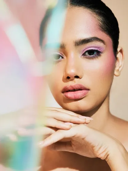Playing with light and color. The iridescent reflection adds a dreamy, futuristic feel to this soft purple and pink makeup look.