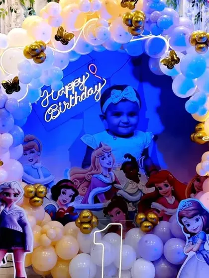 A close-up of the princess party backdrop featuring a photo of the birthday girl.