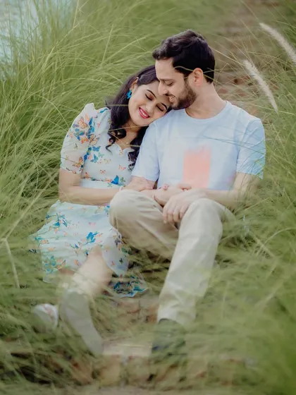 A dreamy and intimate moment for Sayali and Siddhesh, nestled in tall grass. The soft focus and natural setting create a very romantic and peaceful image.