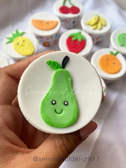 I had so much fun making these fruit-themed fondant toppers. This one is a cute little pear on a vanilla cupcake, perfect for a fruit-themed party.