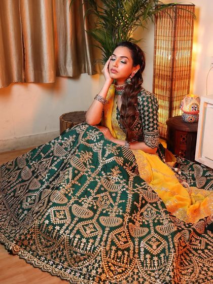 A full-length view of this gorgeous mehendi look. The dramatic braid and bold makeup are balanced by the intricate and beautiful lehenga.