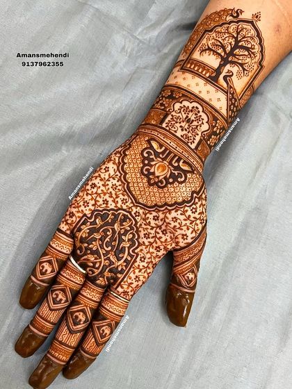 A full view of an intricate design with a peacock and tree motif on the wrist. The palm is filled with delicate floral and geometric patterns for a very dense look.