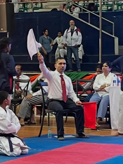 Here I am officiating a kumite (sparring) match at a JKA tournament. As a certified judge, I am responsible for ensuring that contests are conducted safely and according to the strict rules and high standards of the Japan Karate Association.