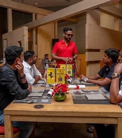 Beyond the DJ booth, my role involves deep collaboration with brands. Here I am at an exclusive Ferrari client dinner, ensuring every detail of the event aligns with the brand's luxury standards.