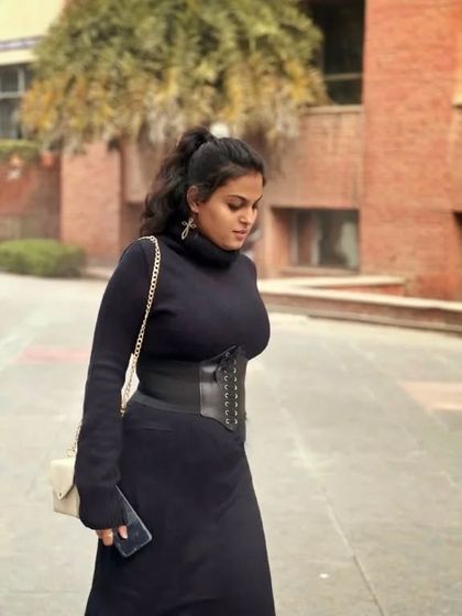 A dark, edgy monochrome look. I styled a black turtleneck dress with a black corset belt to add structure and create an hourglass silhouette. This is a powerful and confident winter outfit.