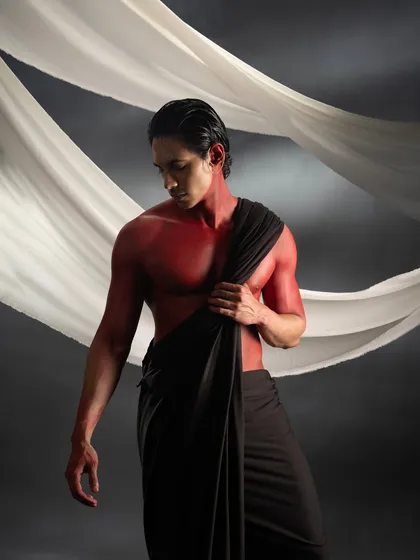 A portrait from the red body paint series, where the focus is on the smooth application of the paint and the way it accentuates the model's physique.