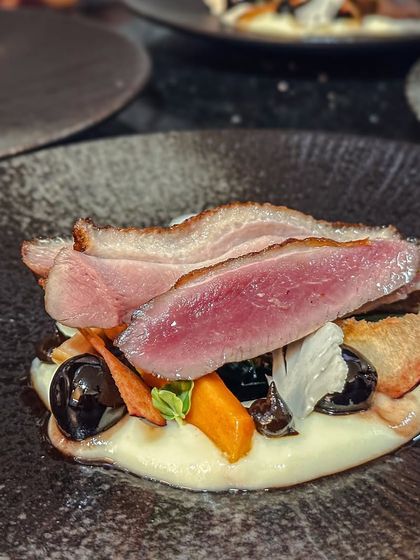 Plated Magret of Duck from my "Four Hands" collaboration dinner. It's served on a cauliflower crème with preserved cherry and port jus.