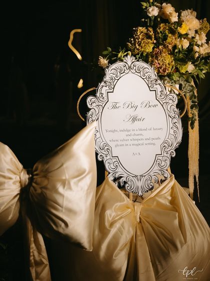 The welcome signage for "The Big Bow Affair," featuring an ornate, vintage-inspired frame and elegant typography, setting a sophisticated tone for the evening.