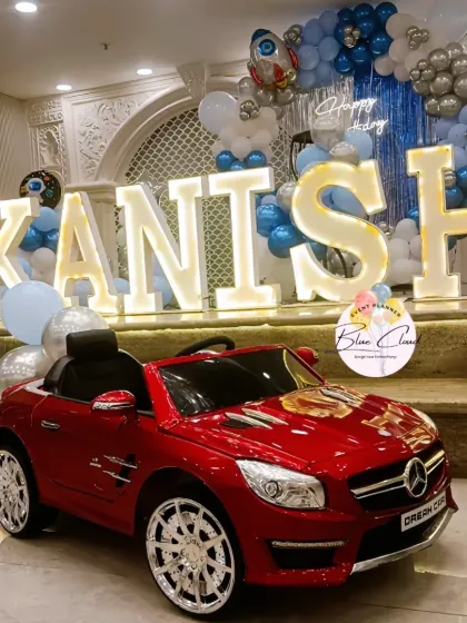 A close-up of the red toy car and marquee letters from the space-themed first birthday party.