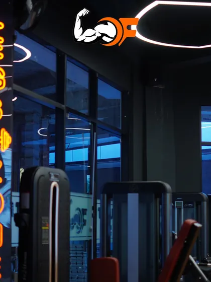 Another angle of our 'Legs Zone' with its distinctive neon sign. The modern lighting and premium equipment create an energizing atmosphere for every workout.