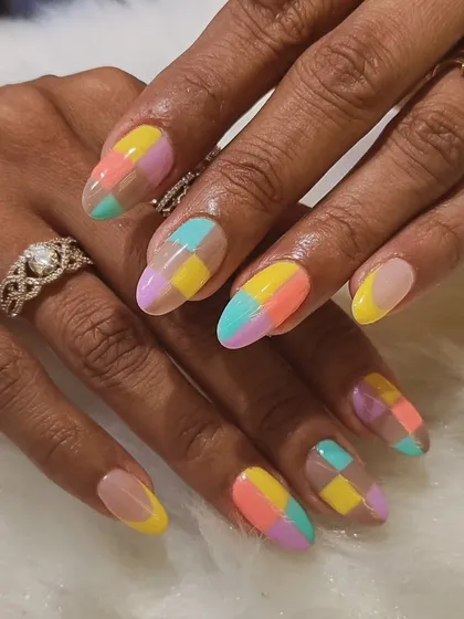 I'm obsessed with these pastel color block nails. The checkerboard pattern in soft shades of yellow, pink, purple, and blue creates a fun, geometric look on long almond nails.