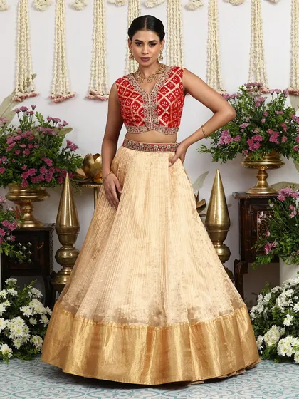 Another angle of the beige and red lehenga, showcasing its timeless appeal and suitability for various wedding functions.