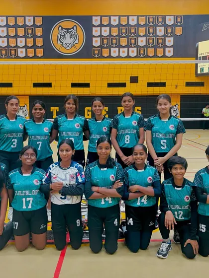 Our girls' team posing for a photo at an indoor tournament. They are ready to compete and represent the academy with pride.