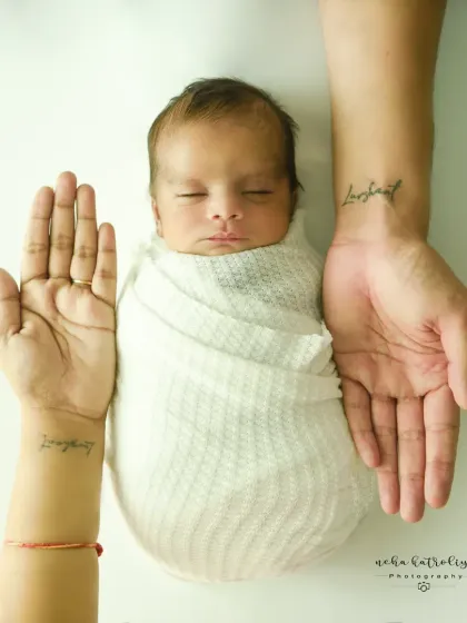 A duplicate of image 2, this is a powerful and popular shot. It beautifully frames the swaddled newborn between the parents' hands, symbolizing love, protection, and the start of a new family.