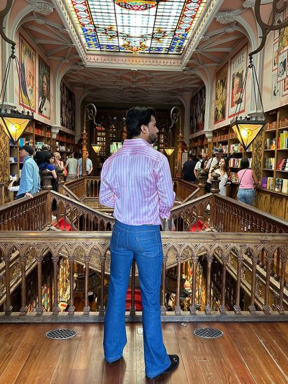A view from the back, this shot highlights the shirt's perfect fit and how it complements the flared jeans for a well-balanced silhouette.