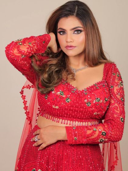 A beautiful portrait of this glamorous red look. The makeup enhances her features, giving her a powerful and confident aura.