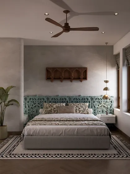 A frontal view of the bed, with its unique, ornately carved teal headboard. The patterns on the rug and cushions add layers of texture and traditional charm, creating a sanctuary that feels grounded and memorable.