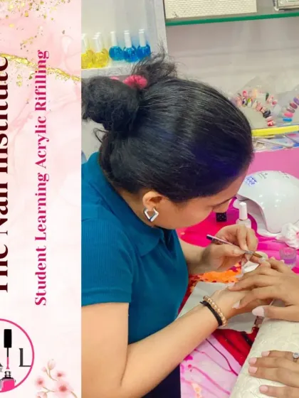 A student practices an acrylic refill, learning how to blend the new acrylic with the old for a seamless finish.