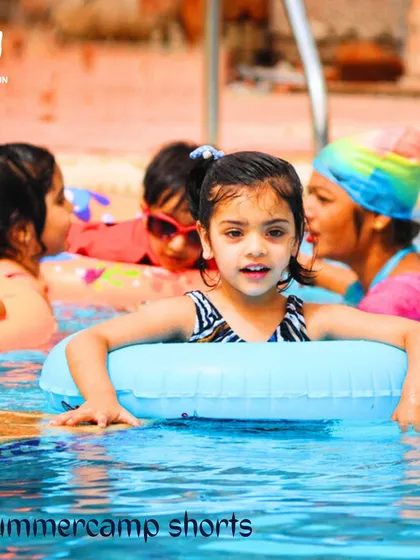 Confidence looks good on her. A young girl in our summer program enjoys her time in the water with a swim ring, learning water safety and comfort at her own pace.
