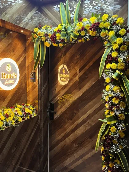 A festive floral arch for a housewarming ceremony. We used bright yellow chrysanthemums and green leaves to create a traditional and auspicious entrance decoration.